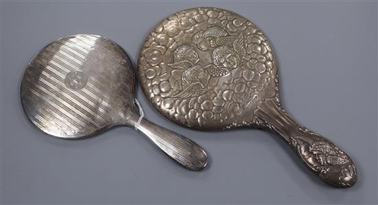 An Edwardian Reynolds Angels decorated silver hand mirror and one other silver mirror.